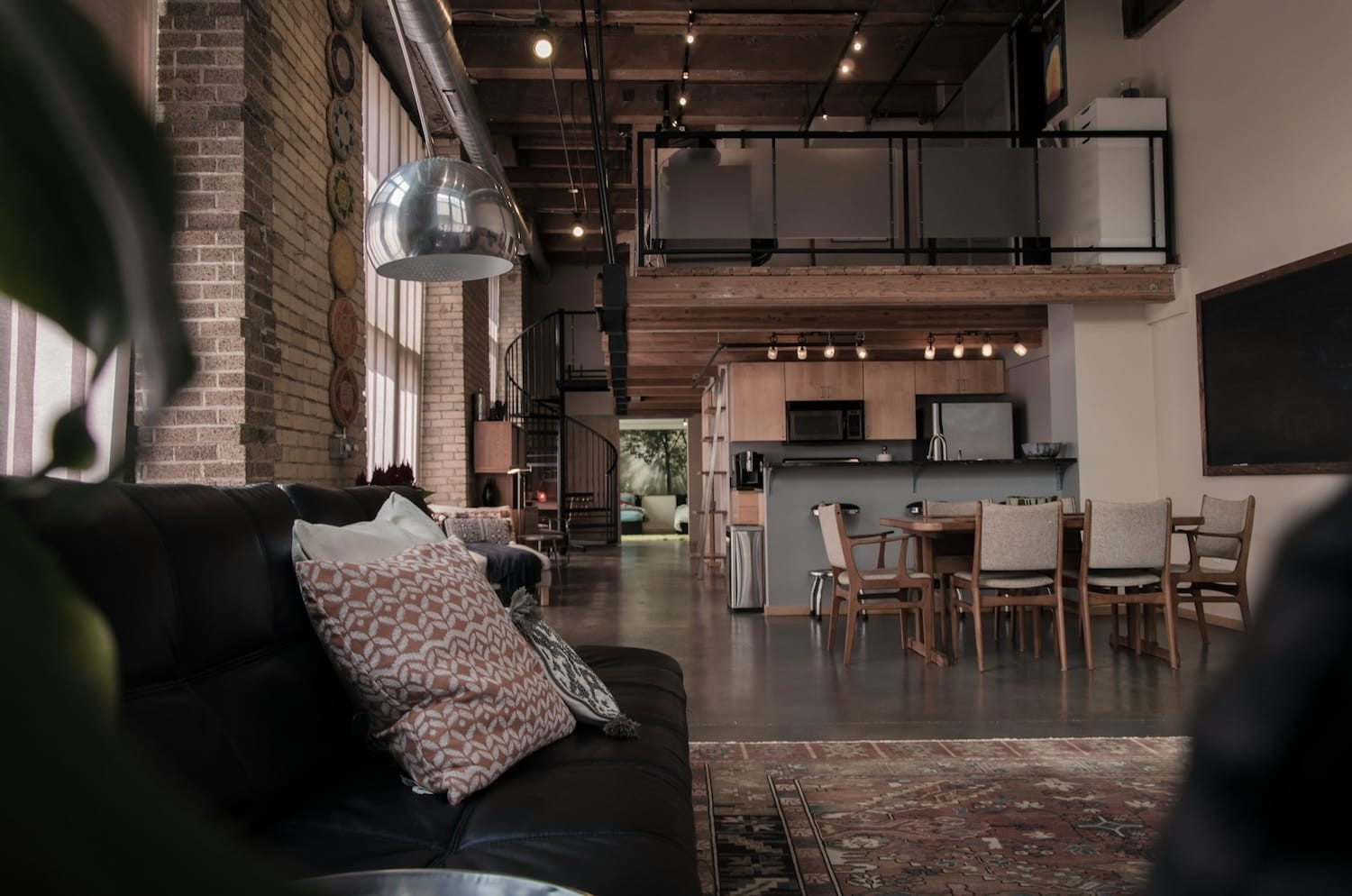 Industrieel interieur met betonnen muren, metalen leidingen en stoere meubels